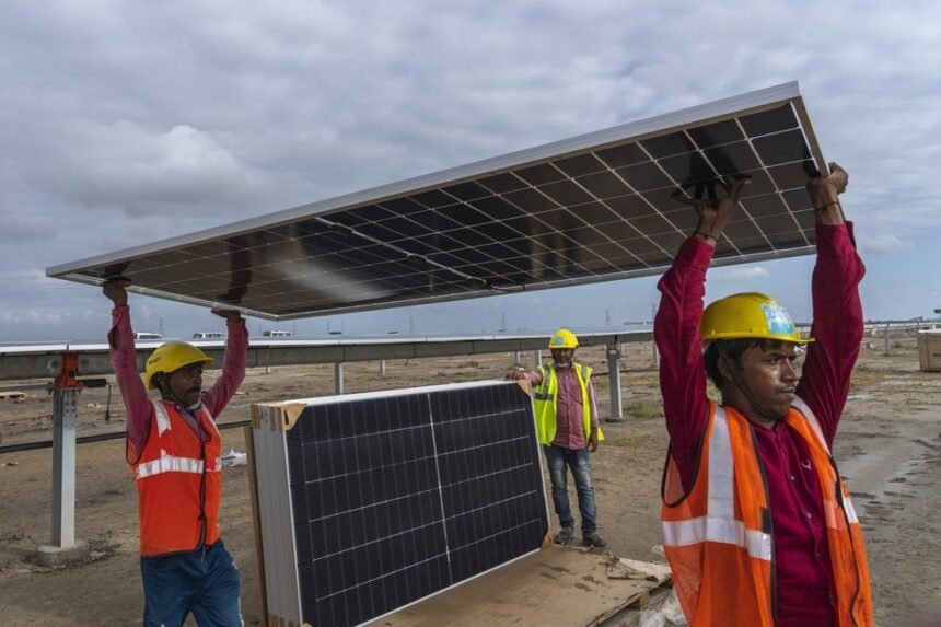 Trabalhadores indianos do setor de energia renováveis  — Foto: AP Photo/Rafiq Maqbool